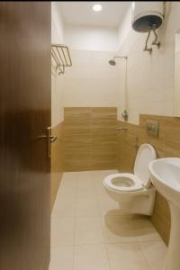 a bathroom with a toilet and a sink at HOTEL SoT PREMIUM in Agra