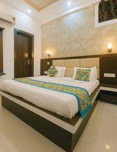 a bedroom with a large bed in a room at HOTEL SoT PREMIUM in Agra