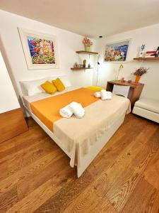 a bedroom with a large bed with towels on it at Casa Venezia San Nicola in Bari