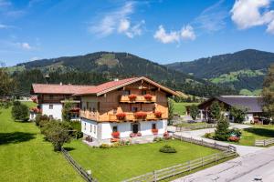 an aerial view of a house with mountains in the background at Landhaus Fingerhof in Flachau