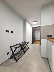 a kitchen with white walls and a table and a counter at EIRA Apartament - Self check-in in Szklarska Poręba +6 photos