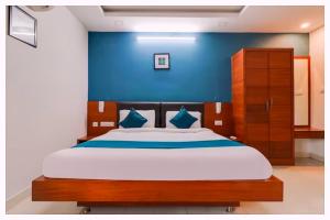a bedroom with a large bed with a blue wall at Hotel Mahamaya Palace Near Naini Lake in Nainital