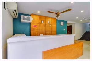 a kitchen with a white counter and a ceiling fan at Hotel Mahamaya Palace Near Naini Lake in Nainital