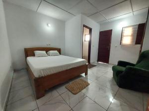 En eller flere senge i et værelse på Petit Cosy Résidences