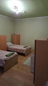 a room with two beds in a room at Svečių namai pas Jud ir Ram in Šiauliai