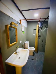 a bathroom with a sink and a toilet at Ritigala Hideaway in Habarana +107 photos