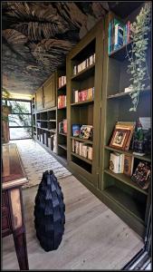 a room with bookshelves and a tire on the floor at L'Eden, villa d'exception entre océan & forêt in Saint-Paul