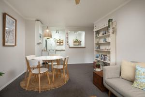 a living room with a table and chairs and a couch at A Stone's Throw in Picton