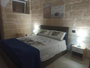 a bedroom with a bed with two pillows on it at CIVICO 33 in Bisceglie