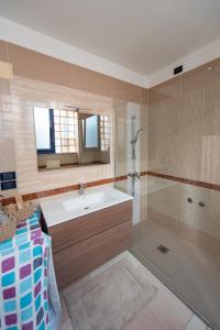 a bathroom with a sink and a shower at Tomati's House in Alba +37 photos
