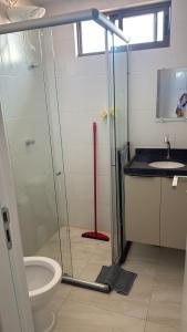 a bathroom with a shower and a toilet and a sink at Refúgio no Bessa in João Pessoa
