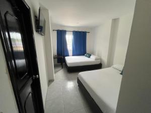 Ένα ή περισσότερα κρεβάτια σε δωμάτιο στο Hotel Villa Marta Cartagena +14 φωτογραφίες