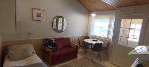 a living room with a red couch and a table at Ruska Levi - Cozy Apartment in the Center in Levi