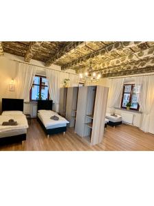 a room with a bunch of beds in it at Katedralna Apartamenty in Legnica