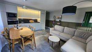 a living room with a table and a couch and a table and chairs at Casa Candeleda Alojamiento Boutique in Candeleda