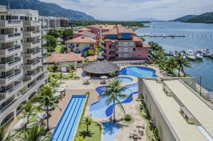 an aerial view of a resort with a pool at Loft Porto Marina Itacuruçá in Mangaratiba