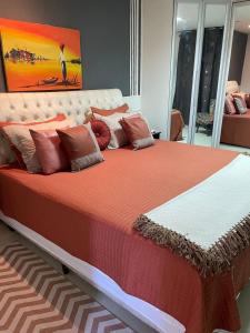 a large bed with pillows on it in a room at Casarão da Brisa in Ilha do Tatu