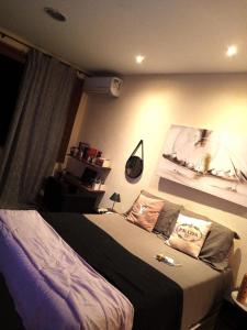 a bedroom with a large bed in a room at Casarão da Brisa in Ilha do Tatu +1 photo