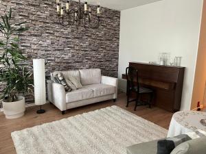 a living room with a couch and a piano at Apartment in Seinäjoki city in Seinäjoki
