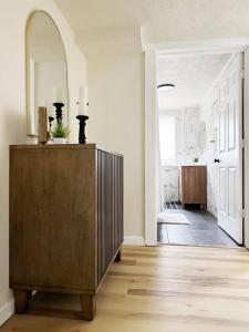 a living room with a dresser and a hallway at The Cardinal Studio Apartments in Evansville