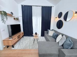 a living room with a couch and a flat screen tv at HDFM Collection - Bungalow Playa del Inglés in Playa del Ingles