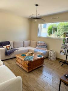 a living room with a couch and a coffee table at Le Clos Es Rio in Plourhan