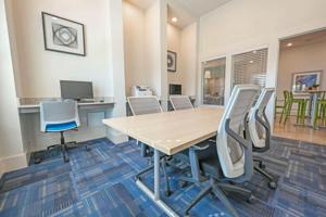 a conference room with a table and chairs at Landing Apartments Austin - Lockhart in Lockhart +43 photos