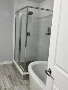 a bathroom with a shower and a bath tub at masters bet room in Whitby