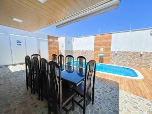 a group of chairs around a table next to a swimming pool at RSOlMAR2025 in Tamandaré