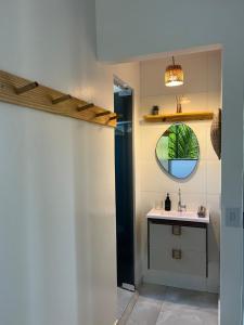 a bathroom with a sink and a mirror at Suítes Preguiça in Sao Jorge