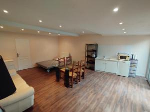 a living room with a couch and a table at Studio A côté Du Plus Beau Marché De France in Béziers +5 photos