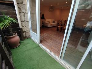 a sliding glass door leading to a living room at Studio A côté Du Plus Beau Marché De France in Béziers