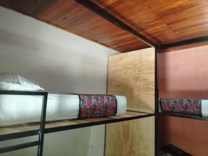 a room with two bunk beds and a wooden ceiling at Backpackers And Travellers Hostel in Neiva +159 photos