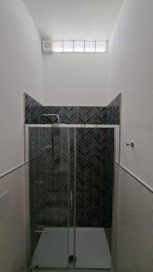 a shower with a glass door in a bathroom at Casetta Giardinetto in Altavilla Milicia