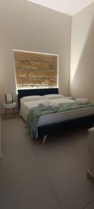 a bedroom with a bed and a brick wall at Casetta Giardinetto in Altavilla Milicia