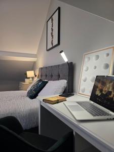 a bedroom with a desk with a laptop on it at The Nook Free Parking Short way City Centre in Hull