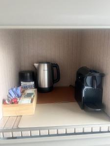 a toy kitchen with a coffee maker and a microwave at Manor Suite Amsterdam in Amsterdam