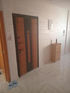 a bathroom with a door and a sink and a mirror at Your best Room to stay near casablanca airport in Deroua