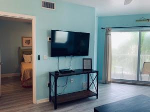 a living room with a flat screen tv on a wall at Winter Sale on Now-Sunset Vistas 303N 100s 5 stars in St Pete Beach