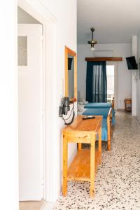 a room with a table and a bed and a mirror at Dilino in Kamari +52 photos