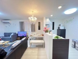 a living room with a couch and a table at Spacious Cozy house in Shinjuku Free parking wifi in Tokyo