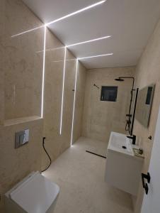 a bathroom with a white toilet and a sink at Zenith DM 4 Otopeni and Therme Self Check-in and Free Parking in Otopeni