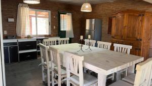 a kitchen with a table and chairs in a kitchen at La Casona Dique Chico in Villa Anizacate +11 photos
