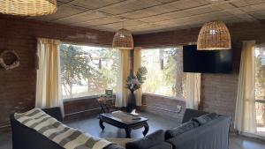 a living room with two couches and a table at La Casona Dique Chico in Villa Anizacate