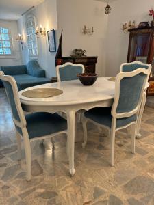 a table and four chairs in a living room at La chambre dorée avec jardin privé in Dar Salah Bey