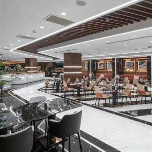 a restaurant with tables and chairs in a building at Grand Sapphire 22 floor B BLock 377, Cypr Północny in Paralimni