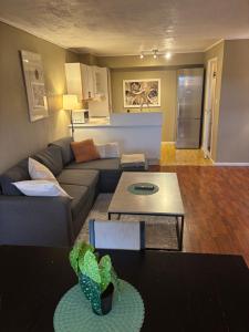 a living room with a couch and a table at JECI Apartment Sandvika Bærum - Great view and Attractive in Østre Jong