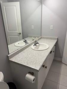 a bathroom with two sinks and a mirror at one bet room in Whitby +5 photos