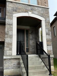 a stone entrance to a house with a staircase at one bet room in Whitby
