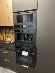 a kitchen with a refrigerator and an oven at Dom w Czerwonej Dolinie Haus im Roten Tal Seidorf Sosnówka` in Sosnówka